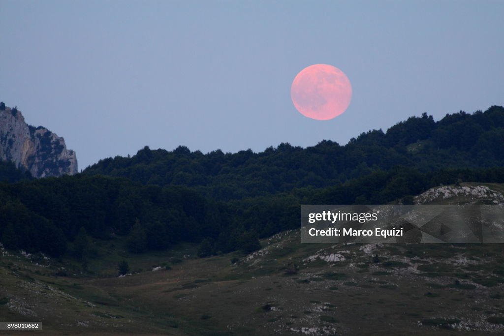 Pink full moon over Campo Imperatore, Abruzzo, Italy, Europe.