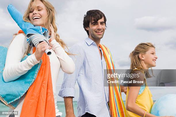 family enjoying vacations on the beach - mother daughter towel fotografías e imágenes de stock