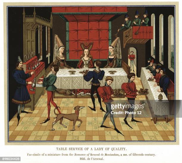 French noblewoman dining with members of her household, waited on by servants and Butler wearing tunic, hose, and long pointed shoes. Trumpeters play...
