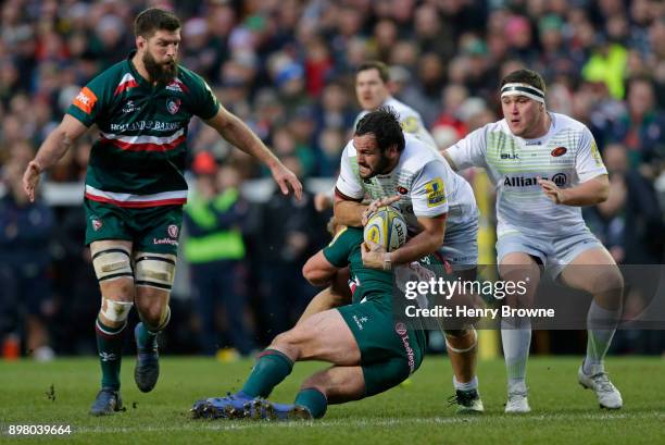 Juan Figallo of Saracens tackled by Tom Youngs of Leicester Tigers during the Aviva Premiership match between Leicester Tigers and Saracens at...