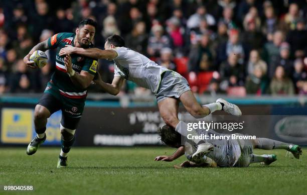 Manu Tuilagi of Leicester Tigers tackled by Alex Lozowski of Saracens during the Aviva Premiership match between Leicester Tigers and Saracens at...