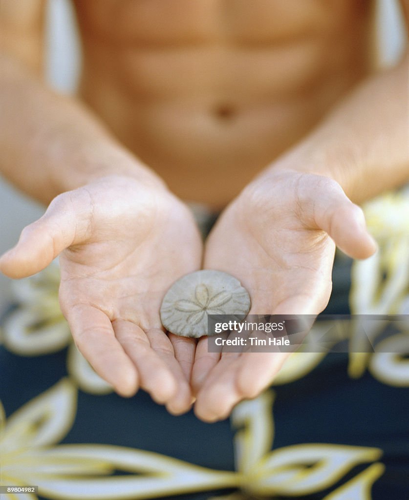 Man holding sand dollar