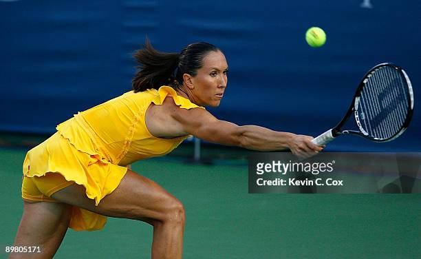 Jelena Jankovic of Serbia returns a shot to Sybille Bammer of Austria during Day 5 of the Western & Southern Financial Group Women's Open on August...