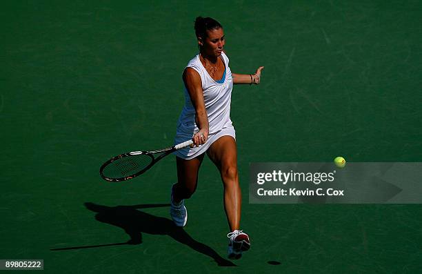 Flavia Pennetta of Italy returns a shot to Daniela Hantuchova of Slovakia on Day 5 of the Western & Southern Financial Group Women's Open on August...