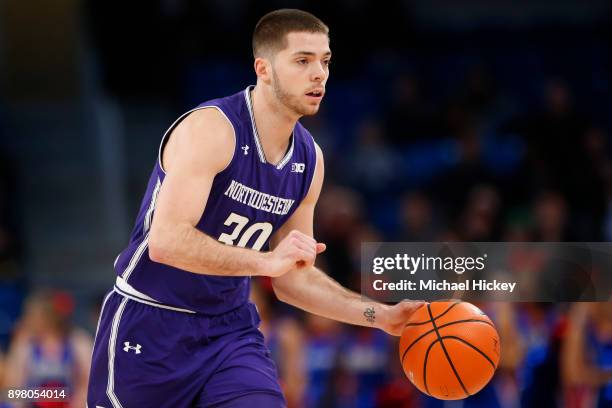 Bryant McIntosh of the Northwestern Wildcats brings the ball up court during the game against the DePaul Blue Demons at Wintrust Arena on December...