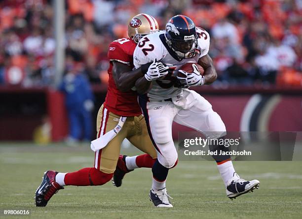 Running back LaMont Jordan of the Denver Broncos runs the ball against Takeo Spikes of the San Francisco 49ers during the preseason game on August...