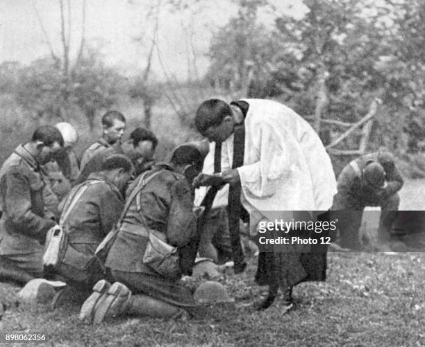 World War I, New Zealand troops taking Holy Communion administered by an Army chaplain in the open air.
