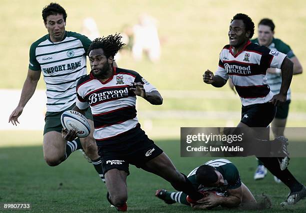 Lote Tuqiri of West Harbour is tackled during the round 20 Shute Shield match between Warringah and West Harbouron at Pittwater Rugby Park on August...