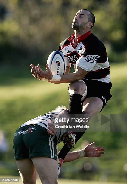 Nick Reily of West Harbour jumps for the ball as he's being tackled by Beau Robinson of Warringah during the round 20 Shute Shield match between...