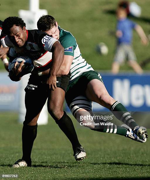 Henry Seavula of West Harbour is tackled during the round 20 Shute Shield match between Warringah and West Harbouron at Pittwater Rugby Park on...