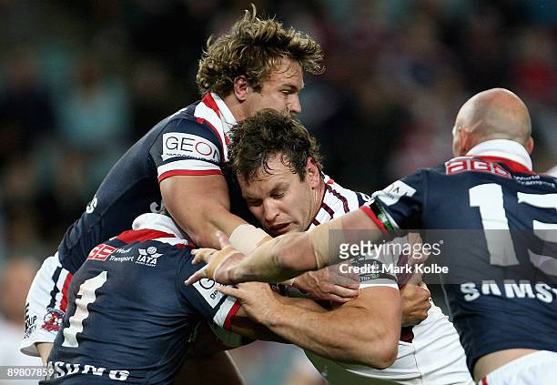 Josh Perry of the Sea Eagles is tackled during the round 23 NRL match between the Sydney Roosters and the Manly Warringah Sea Eagles at the Sydney...