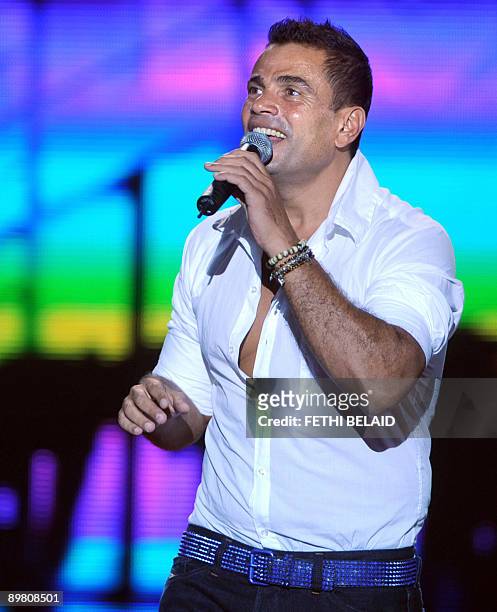 Egyptian singer Amr Diab performs during the 45th edition of the International Carthage festival, late on August 14 at the Roman theatre in Carthage,...