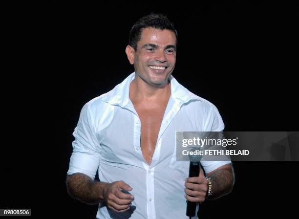 Egyptian singer Amr Diab performs during the 45ft session of the International Carthage festival, on August 14 at the Romain theatre in Carthage,...