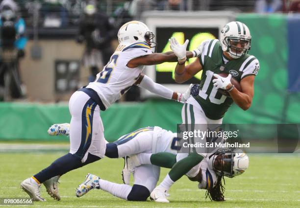 Jermaine Kearse of the New York Jets attempts to avoid the tackle attempt of Casey Hayward of the Los Angeles Chargers in an NFL game at MetLife...