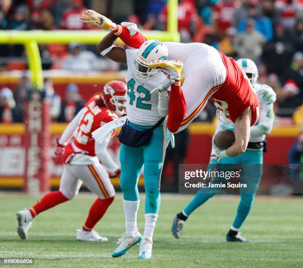 Tight end Travis Kelce of the Kansas City Chiefs gets flipped upside down after leaving his feet on a tackle by defensive back Alterraun Verner of...