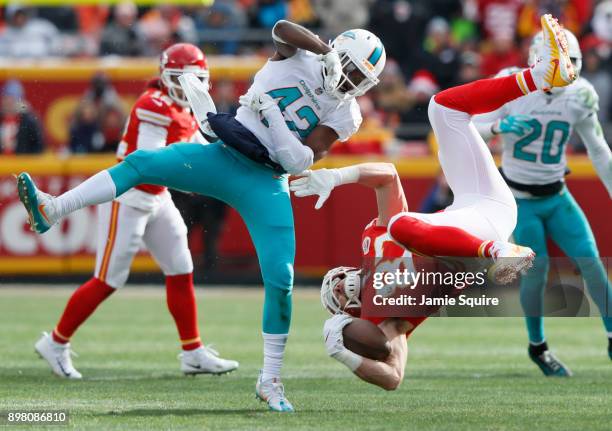 Tight end Travis Kelce of the Kansas City Chiefs gets flipped upside down after leaving his feet on a tackle by defensive back Alterraun Verner of...