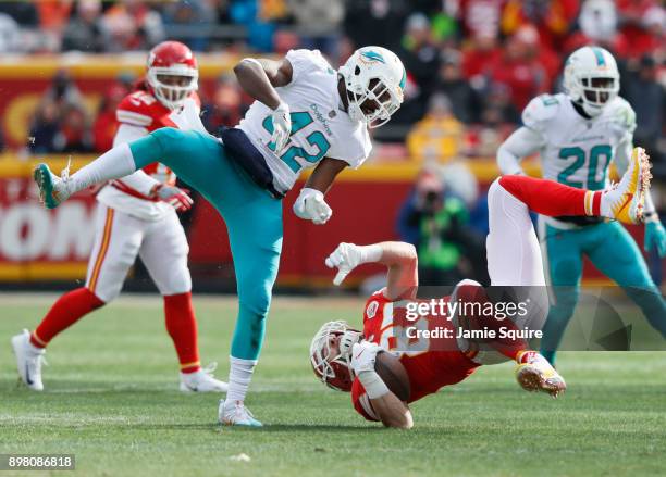 Tight end Travis Kelce of the Kansas City Chiefs gets flipped upside down after leaving his feet on a tackle by defensive back Alterraun Verner of...