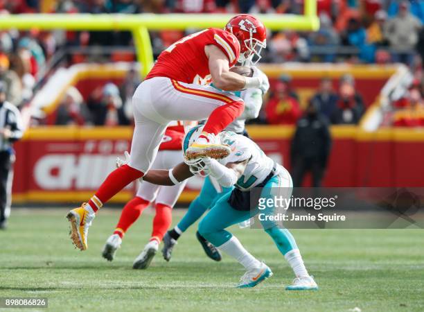 Tight end Travis Kelce of the Kansas City Chiefs gets flipped upside down after leaving his feet on a tackle by defensive back Alterraun Verner of...