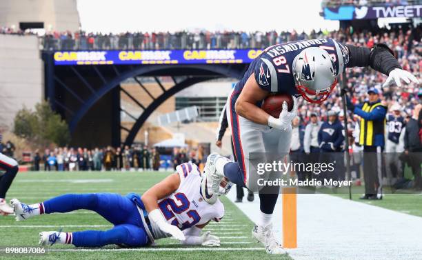 Rob Gronkowski of the New England Patriots catches a touchdown pass as he is defended by Micah Hyde of the Buffalo Bills during the second quarter of...