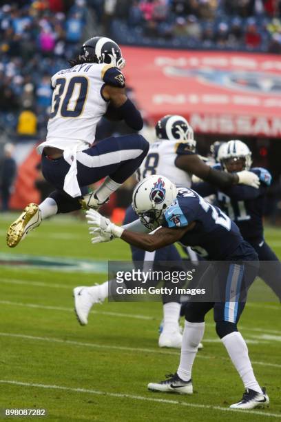 Running Back Todd Gurley II of the Los Angeles Rams hurdles Corner Back Brice McCain of the Tennessee Titans at Nissan Stadium on December 24, 2017...