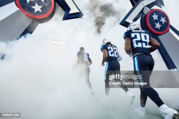 Running Back Derrick Henry, Quarterback Marcus Mariota and Running Back DeMarco Murray of the Tennessee Titans take the field before a game against...