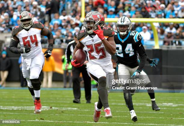 Peyton Barber of the Tampa Bay Buccaneers runs the ball against the Carolina Panthers in the first quarter at Bank of America Stadium on December 24,...