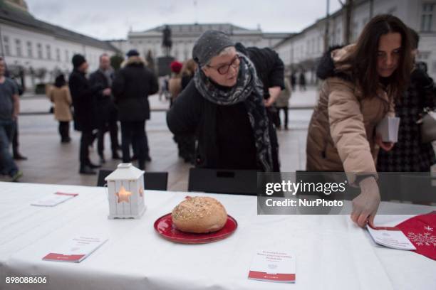 Woman stands near table during Christmas Eve dinner organized by Polish opposition groups near Presidental Palace in Warsaw on December 24, 2017.