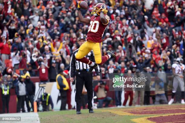 Wide receiver Jamison Crowder of the Washington Redskins celebrates after catching a touchdown pass against the Denver Broncos in the second quarter...