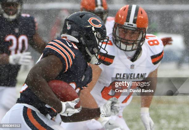 Tarik Cohen of the Chicago Bears carries the football against Seth DeValve of the Cleveland Browns in the first quarter at Soldier Field on December...