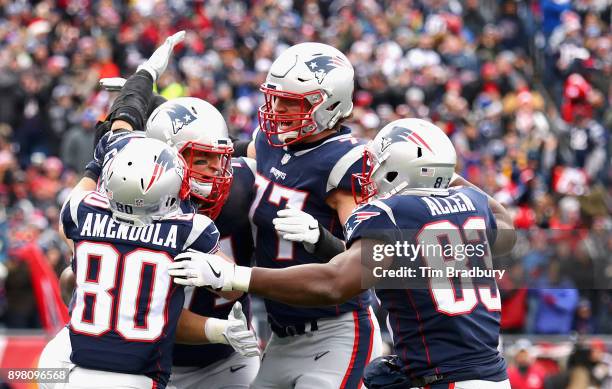 Rob Gronkowski of the New England Patriots reacts with Nate Solder, Danny Amendola, and Dwayne Allen after catching a touchdown pass during the...