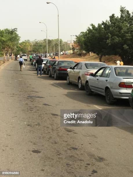 Cars queue to get fuel from fuel stations as Many fuel stations are shut while a few others sell at an unofficial rate between 200 and 400 naira in...