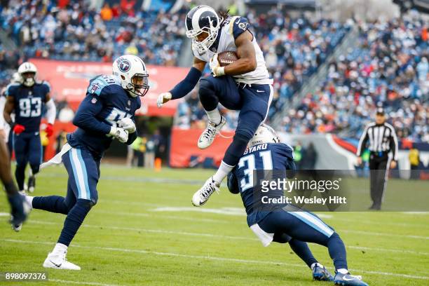 Running Back Todd Gurley II of the Los Angeles Rams jumps over Safety Kevin Byard of the Tennessee Titans at Nissan Stadium on December 24, 2017 in...