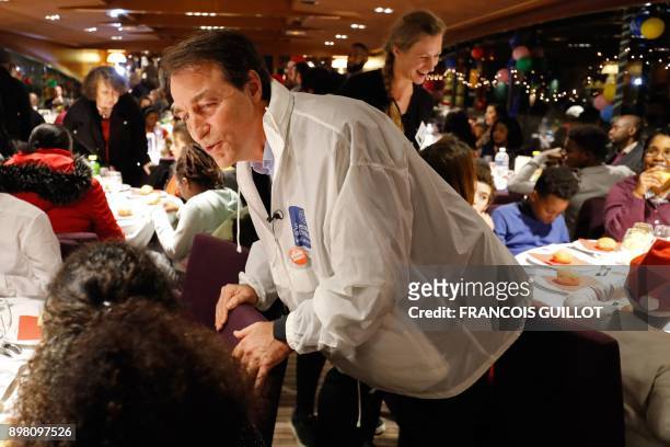 Bernard Thibaud, Secretary general of the 'Secours Catholique-Caritas', a Catholic linked charity group, speaks with guests during a Christmas eve...
