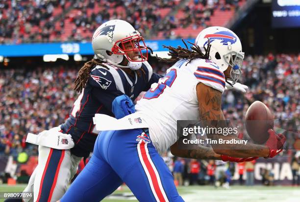 Kelvin Benjamin of the Buffalo Bills catches a touchdown pass as he is defended by Stephon Gilmore of the New England Patriots during the second...