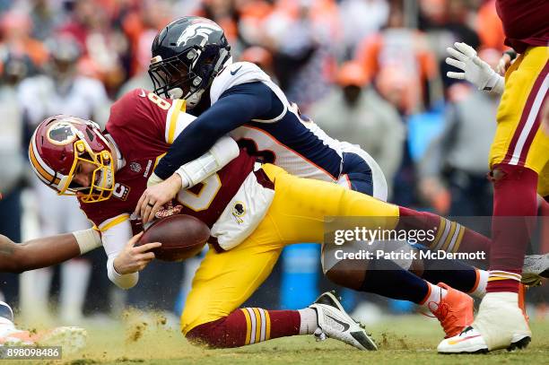 Quarterback Kirk Cousins of the Washington Redskins is sacked by outside linebacker Von Miller of the Denver Broncos in the second quarter at...