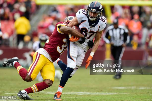 Wide receiver Jordan Taylor of the Denver Broncos is tackled by cornerback Fabian Moreau of the Washington Redskins after catching a pass in the...