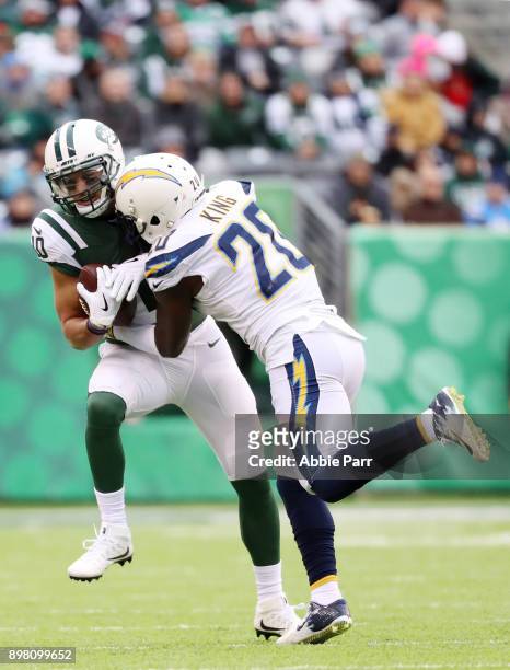 Jermaine Kearse of the New York Jets is tackled by Desmond King of the Los Angeles Chargers during the first half of an NFL game at MetLife Stadium...