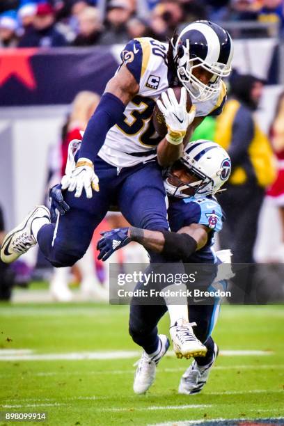 Running Back Todd Gurley II of the Los Angeles Rams carries the ball against Corner Back Tye Smith of the Tennessee Titans at Nissan Stadium on...