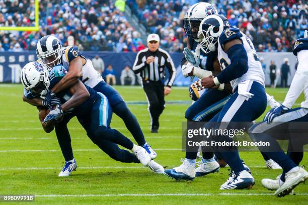 Wide Receiver Corey Davis of the Tennessee Titans carries the ball against Corner Back Trumaine Johnson of the Los Angeles Rams at Nissan Stadium on...