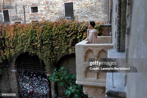 An actress representing Juliet stands on 'Juliet's Balcony' in Via Cappello 23, which is today known as “Juliet’s House” on November 20, 2017 in...