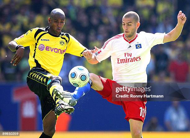 Felipe Santana of Dortmund battles for the ball with Mladen Petric of Hamburg during the Bundesliga match between Hamburger SV and Borussia Dortmund...