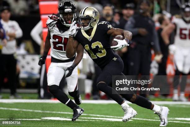 Michael Thomas of the New Orleans Saints runs with the ball as Desmond Trufant of the Atlanta Falcons defends during the second half of a at the...