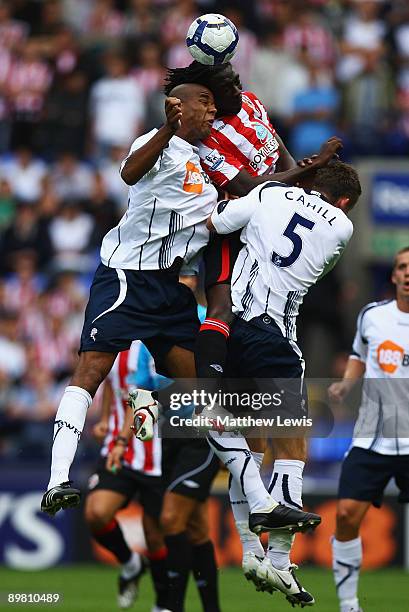 Zat Knight and Gary Cahill of Bolton challenge for the ball with Kenwyne Jones of Sunderland during the Barclays Premier League match between Bolton...