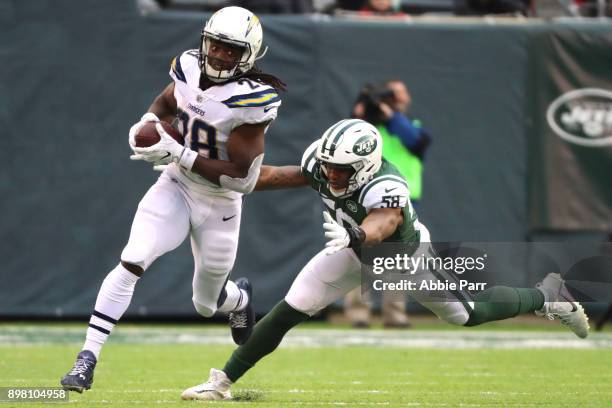 Melvin Gordon of the Los Angeles Chargers avoids the tackle attempt from Darron Lee of the New York Jets during the second half of an NFL game at...