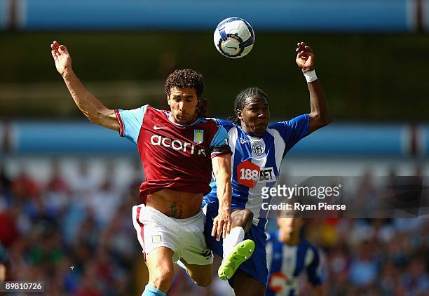 Hugo Rodallega of Wigan competes for the ball against Carlos Cuellar of Aston Villa during the Barclays Premier League match between Aston Villa and...