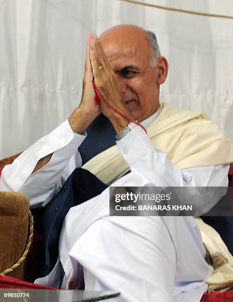 Afghan presidential candidate Ashraf Ghani Ahmadzai gestures as he sits during an election campaign meeting in Kandahar on August 15, 2009....