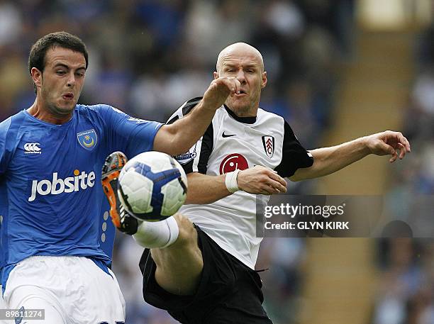 Portsmouth's Irish defender Marc Wilson vies with Fulham's English striker Andy Johnson during the Premier League football match between Portsmouth...