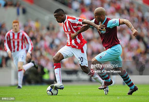 Ricardo Fuller of Stoke City is challenged by Clarke Carlisle of Burnley during the Barclays Premier League match Between Stoke City and Burnley at...