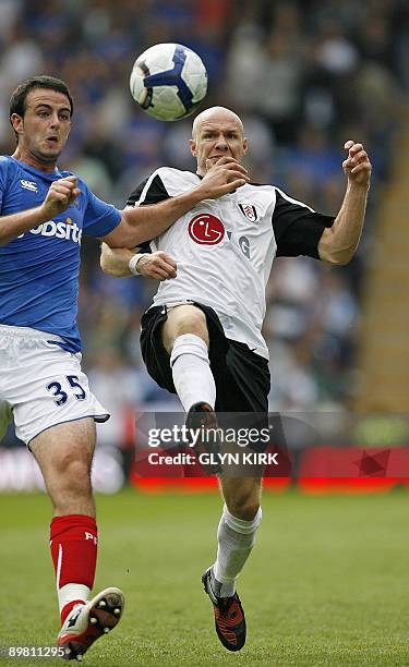 Portsmouth's Irish Defender Marc Wilson vies with Fulham's English striker Andy Johnson during the Premier League football match between Portsmouth...