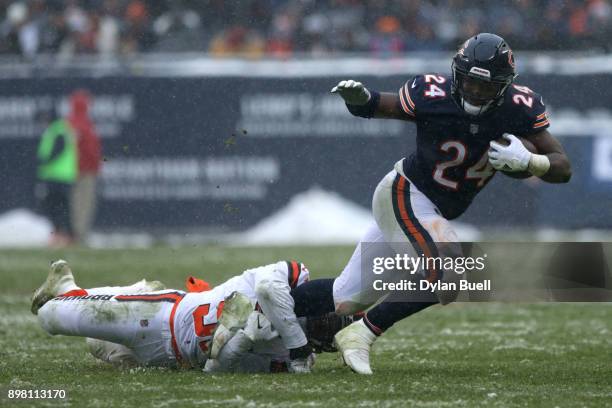 James Burgess of the Cleveland Browns grabs Jordan Howard of the Chicago Bears in the third quarter at Soldier Field on December 24, 2017 in Chicago,...